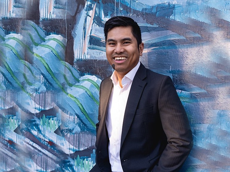 Patrick Galang portrait in front of a mural